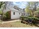 Backyard view of the house with a deck and lush landscaping, surrounded by mature trees at 2115 Hawthorne Pt, Marietta, GA 30062