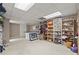 Finished basement area with a built-in shelving unit and open floor plan at 2115 Hawthorne Pt, Marietta, GA 30062