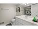 Clean, white bathroom with a toilet, sink, mirror, and shower with a patterned curtain at 2115 Hawthorne Pt, Marietta, GA 30062