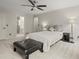 Well-lit bedroom with a ceiling fan, carpeted floors, and an ensuite bathroom at 2115 Hawthorne Pt, Marietta, GA 30062