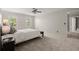 Bright bedroom with a ceiling fan, carpeted floors, and two windows for natural light at 2115 Hawthorne Pt, Marietta, GA 30062