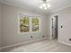 Bedroom with neutral paint, carpet flooring, and large window with backyard view at 2115 Hawthorne Pt, Marietta, GA 30062