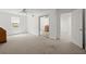 Spacious carpeted bedroom featuring a window, mirrored closet doors, and doorway to another room at 2115 Hawthorne Pt, Marietta, GA 30062