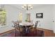 Bright dining room featuring a wooden table, elegant chairs, and natural light from large windows at 2115 Hawthorne Pt, Marietta, GA 30062