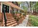 Charming brick home featuring a welcoming front entrance with a classic black door and well-maintained landscaping at 2115 Hawthorne Pt, Marietta, GA 30062