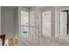 Bright hallway with white railing leading to bathroom, bedroom, and additional doors at 2115 Hawthorne Pt, Marietta, GA 30062
