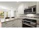 Well-equipped kitchen with stainless steel appliances, granite countertops, and ample cabinet space at 2115 Hawthorne Pt, Marietta, GA 30062