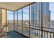 Enclosed balcony offering stunning city views and a cozy seating area at 300 Peachtree Ne St # 18I, Atlanta, GA 30308