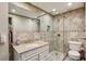 Modern bathroom featuring a glass-enclosed shower, granite countertop, and stylish fixtures at 300 Peachtree Ne St # 18I, Atlanta, GA 30308