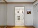 Hallway view with a glimpse into the well-lit, modern kitchen, featuring white cabinetry at 300 Peachtree Ne St # 18I, Atlanta, GA 30308