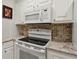 Bright kitchen featuring a modern cooktop stove and sleek countertops at 300 Peachtree Ne St # 18I, Atlanta, GA 30308