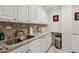 Well-equipped kitchen with stainless steel sink, granite countertops, and white cabinets at 300 Peachtree Ne St # 18I, Atlanta, GA 30308