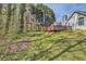 Well-maintained backyard and deck with green grass and wooded perimeter at 534 Creekstone Dr, Jonesboro, GA 30236