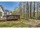 Spacious backyard with wooden deck, lawn, and mature trees at 534 Creekstone Dr, Jonesboro, GA 30236