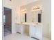 Bright bathroom with double vanity, white cabinetry, and sleek tile flooring at 534 Creekstone Dr, Jonesboro, GA 30236