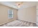 Neutral bedroom with a ceiling fan, a window and plush carpet flooring at 534 Creekstone Dr, Jonesboro, GA 30236