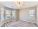 Bright bedroom with large windows, ceiling fan, and neutral carpet at 534 Creekstone Dr, Jonesboro, GA 30236