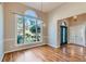 Bright dining room featuring hardwood floors, a chandelier, large windows, and easy access to the foyer at 534 Creekstone Dr, Jonesboro, GA 30236