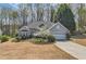 Inviting single-Gathering home showcasing a well-maintained lawn and an attached two-car garage, framed by mature trees at 534 Creekstone Dr, Jonesboro, GA 30236