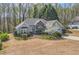Charming single-Gathering home featuring stone accents and a manicured lawn, set amidst a lush, wooded backdrop at 534 Creekstone Dr, Jonesboro, GA 30236