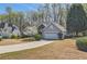 Beautiful single-Gathering home with stone details and a spacious driveway, surrounded by mature trees and lush landscaping at 534 Creekstone Dr, Jonesboro, GA 30236