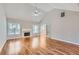 Bright living room with hardwood floors, a fireplace, a ceiling fan, and French doors leading to other rooms at 534 Creekstone Dr, Jonesboro, GA 30236