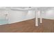 Spacious basement with wood-look flooring, recessed lighting, white walls, and access to the laundry room at 175 Holly Nw Rd, Atlanta, GA 30314