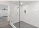 Bright bathroom featuring a glass shower with white marble tile and stylish black and white patterned floor at 175 Holly Nw Rd, Atlanta, GA 30314
