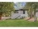 Charming renovated home featuring a white brick exterior and staircase leading to the front entrance at 175 Holly Nw Rd, Atlanta, GA 30314