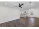 Open-concept living area showcasing dark laminate flooring and a view into the adjacent kitchen at 175 Holly Nw Rd, Atlanta, GA 30314