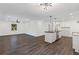 Open-concept living area with dark laminate flooring and a view into the adjacent kitchen at 175 Holly Nw Rd, Atlanta, GA 30314
