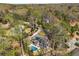 Aerial view of a home featuring a backyard swimming pool, stone chimney and ample backyard privacy with mature landscaping at 570 Glen Eagles Se Cir, Marietta, GA 30067