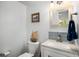 Powder room with stylish mirror, granite countertop, and new fixtures at 570 Glen Eagles Se Cir, Marietta, GA 30067