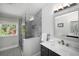 Bright bathroom featuring a glass shower, stylish vanity, and a large window at 570 Glen Eagles Se Cir, Marietta, GA 30067