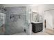 Modern bathroom featuring a gray tiled shower with a glass door and a stylish vanity at 570 Glen Eagles Se Cir, Marietta, GA 30067