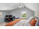 Cozy gray bedroom with a comfortable bed, a desk and dual monitors, and natural light at 570 Glen Eagles Se Cir, Marietta, GA 30067