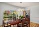 Elegant dining room with large window, hardwood floors, and a stylish chandelier at 570 Glen Eagles Se Cir, Marietta, GA 30067