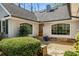 Charming home entrance featuring a stone walkway, tidy landscaping and a wood front door with glass panels at 570 Glen Eagles Se Cir, Marietta, GA 30067