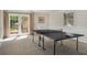 Well-lit game room featuring a ping pong table and access to the outdoors through double doors at 570 Glen Eagles Se Cir, Marietta, GA 30067