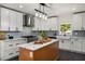Renovated kitchen features stainless steel appliances, an island, and modern lighting at 570 Glen Eagles Se Cir, Marietta, GA 30067