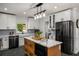 Well-equipped kitchen boasts an island, stainless steel appliances, and stylish white cabinetry at 570 Glen Eagles Se Cir, Marietta, GA 30067