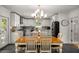 Bright, eat-in kitchen featuring white cabinets, stainless steel appliances, and a stylish modern chandelier at 570 Glen Eagles Se Cir, Marietta, GA 30067