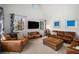 Cozy living room featuring comfortable seating, a mounted television, and natural light at 570 Glen Eagles Se Cir, Marietta, GA 30067