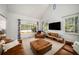 Bright living room features vaulted ceilings, plentiful natural light, and cozy, neutral decor at 570 Glen Eagles Se Cir, Marietta, GA 30067