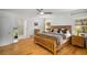 Cozy main bedroom with a wooden bed frame, hardwood floors, and an ensuite bathroom at 570 Glen Eagles Se Cir, Marietta, GA 30067