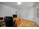 Home office featuring wood floors, a large desk, and a view of the outdoors at 570 Glen Eagles Se Cir, Marietta, GA 30067