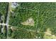 Aerial view of the acreage including a home and mature trees surrounding it at 12551 Alcovy Rd, Covington, GA 30014
