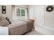 Bright bedroom with comfortable bed, two windows, and a serene neutral color palette at 12551 Alcovy Rd, Covington, GA 30014