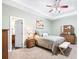 Cozy bedroom features a tray ceiling, neutral carpet, and a dresser at 12551 Alcovy Rd, Covington, GA 30014