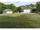 Home exterior with large lawn, two-car garage, extra garage, and a basketball hoop at 12551 Alcovy Rd, Covington, GA 30014